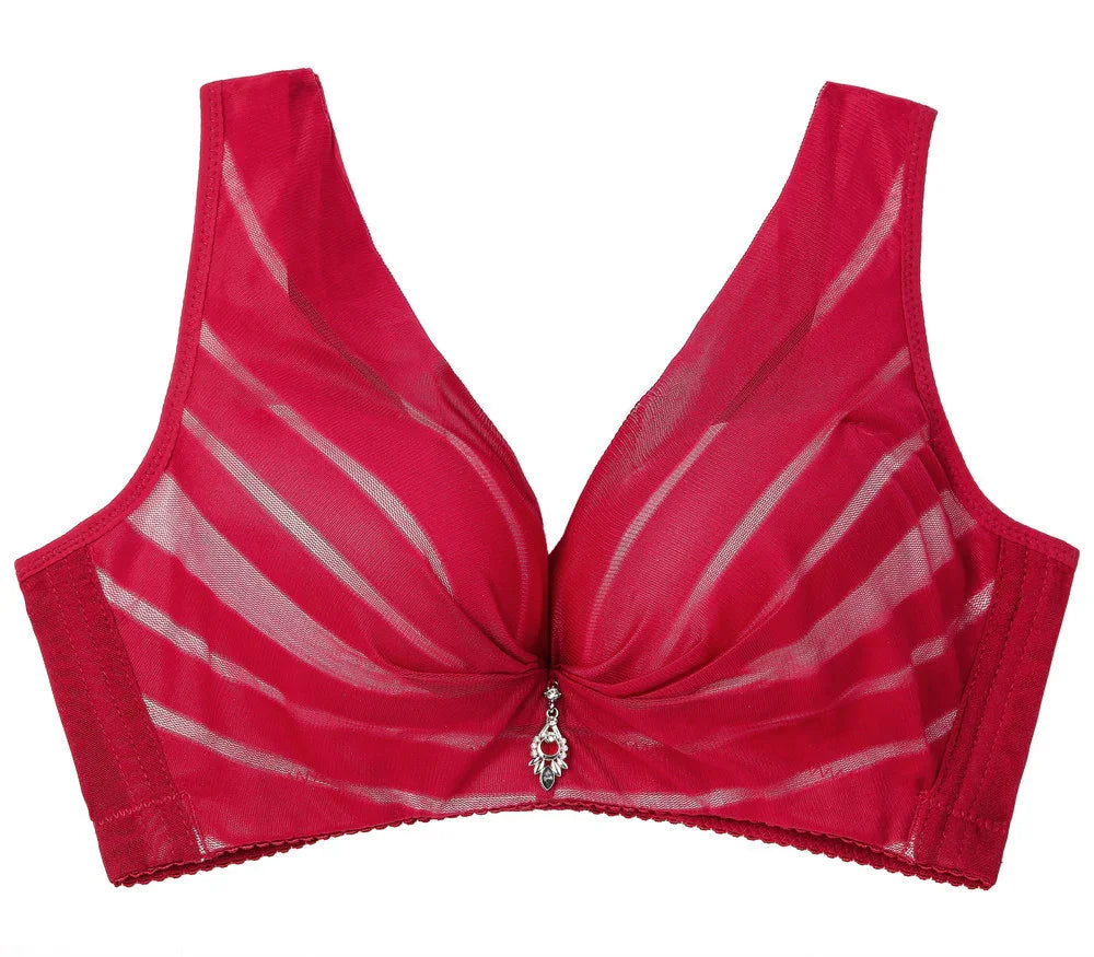 Red wireless bra with sheer striped mesh and decorative charm, designed for comfort and elegance
