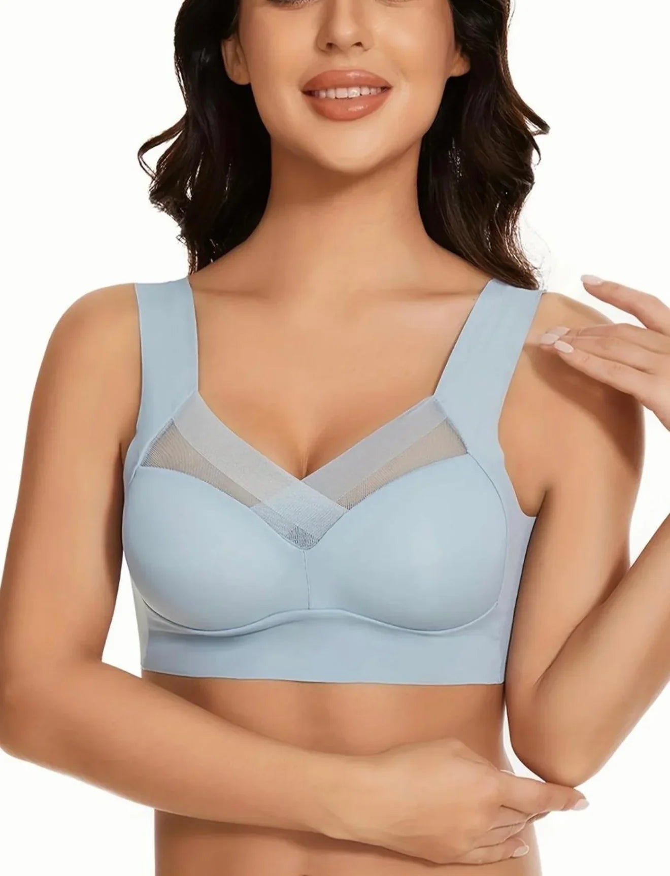 Woman wearing a light blue bra with mesh detail, showcasing comfortable women’s undergarment.