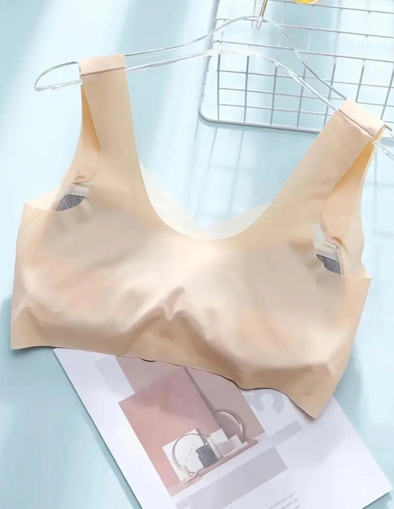 Seamless nude women’s bra made from soft, breathable fabric on a hanger, ideal for everyday comfort.